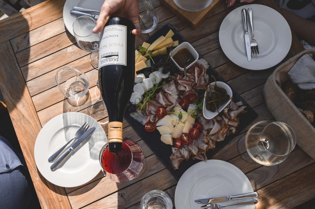 cheese_ham_plate_wine cheese and ham plate with white wine and red wine